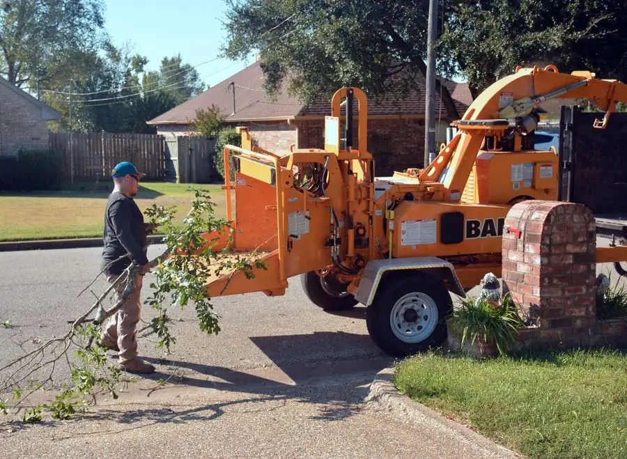 Wood chipper at the curb of a home clearing branches